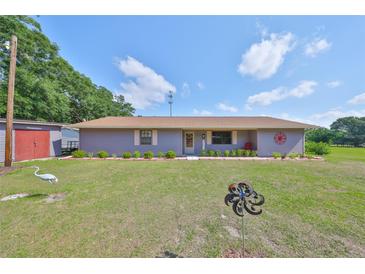 Charming single-story home featuring a well-maintained lawn and inviting curb appeal at 13208 Sydney Rd, Dover, FL 33527