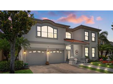 Stunning two-story home with a two-car garage, lush landscaping, and a beautiful entryway at 15630 N Himes Ave, Tampa, FL 33618