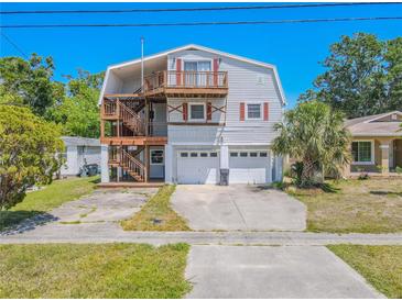 Charming two-story home featuring a unique double-deck design and two-car garage at 503 Chestnut St, Oldsmar, FL 34677