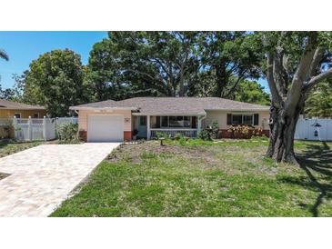 Charming ranch-style home with a brick driveway and mature trees offering shade at 5072 98Th Way, St Petersburg, FL 33708
