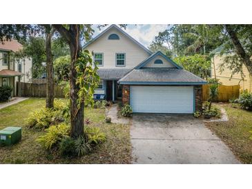 Charming home featuring lush landscaping, a two-car garage, and a beautifully maintained front yard at 678 Greenglen Ln, Palm Harbor, FL 34684