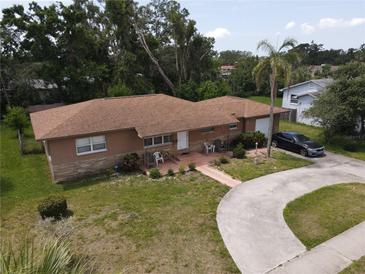 A charming single-story home with a covered porch and attached garage, surrounded by lush landscaping at 1710 26Th S Ave, St Petersburg, FL 33712