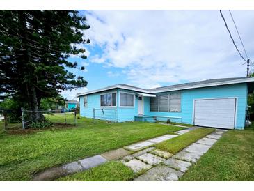 Charming single-story home with a well-maintained lawn and an attached single-car garage at 300 144Th Ave, Madeira Beach, FL 33708