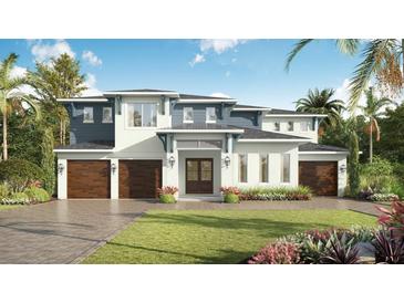 Beautiful two-story home with a three-car garage, manicured lawn, and inviting curb appeal at 3914 W San Rafael St, Tampa, FL 33629