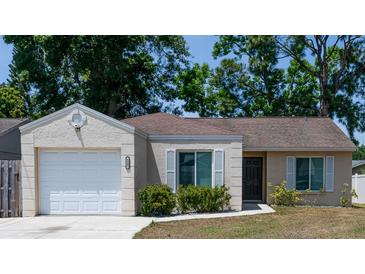 Charming single-story home with well-maintained landscaping, attached garage and neutral paint at 6805 S Gabrielle St, Tampa, FL 33611