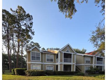Inviting two-story condo with a screened in porch and mature trees at 9481 Highland Oak Dr # 1003, Tampa, FL 33647
