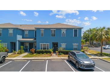 Bright two-story townhome with manicured landscaping and parking in front at 12805 Kings Crossing Dr, Gibsonton, FL 33534