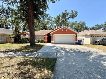 Charming single-story home featuring a spacious two-car garage and well-maintained landscaping at 1813 Landside Dr, Valrico, FL 33594