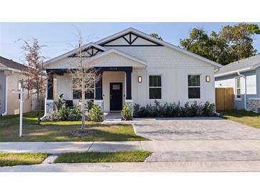 Charming home with a well-manicured lawn, stylish black and white accents, and a welcoming front entrance at 2150 43Rd N Ter, St Petersburg, FL 33714
