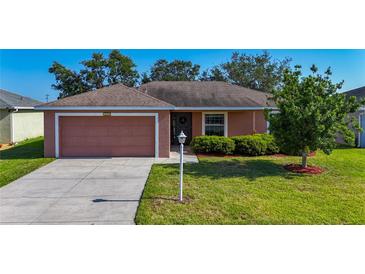 Charming single-story home with a well-manicured lawn and attached two-car garage at 3212 55Th E St, Palmetto, FL 34221