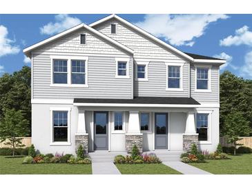 Charming two-story home featuring a welcoming entrance and beautifully landscaped front yard, perfect for suburban living at 404 N Westland St # 1, Tampa, FL 33609