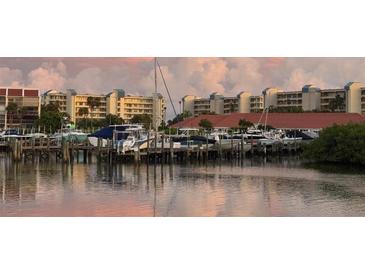 Scenic marina view featuring boats docked in calm waters, backed by waterfront condo buildings at 7930 Sun Island S Dr # 104, South Pasadena, FL 33707