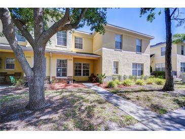 Charming two-story townhome with well-manicured landscaping and inviting walkway at 10928 Brickside Ct, Riverview, FL 33579