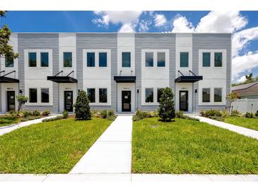 Attractive townhomes featuring a landscaped lawn and matching trees and shrubbery at 3402 E 28Th Ave # 6, Tampa, FL 33605