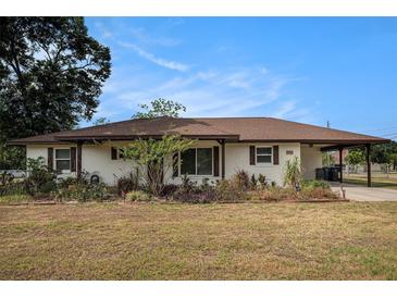 Charming single-story home featuring a well-kept yard and a convenient carport at 3515 Bell Farms Dr, Plant City, FL 33566