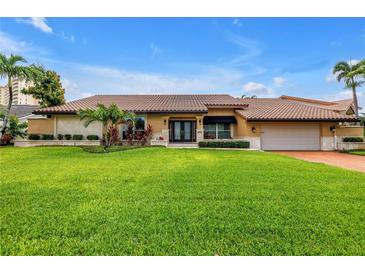 Charming single-story home featuring a well-manicured lawn and a classic tile roof at 4935 58Th S Ave, St Petersburg, FL 33715