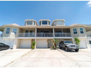 Three-story exterior showcasing garages, balconies, and well-maintained facade of the townhome at 8304 Aquila St, Port Richey, FL 34668