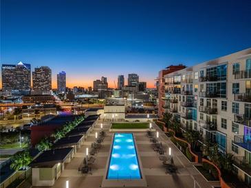 Rooftop pool with city skyline views at dusk at 1120 E Kennedy Blvd # 1228, Tampa, FL 33602