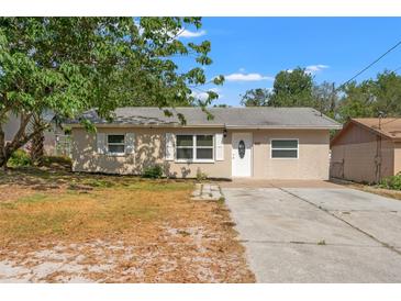 Charming single-story home featuring a well-manicured lawn and a private driveway at 15124 Omaha St, Hudson, FL 34667