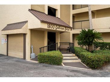 Welcoming entrance to 1800 Golfview Drive with well-manicured landscaping, convenient seating, and ample parking at 1817 Golfview Dr # 1817, Tarpon Springs, FL 34689