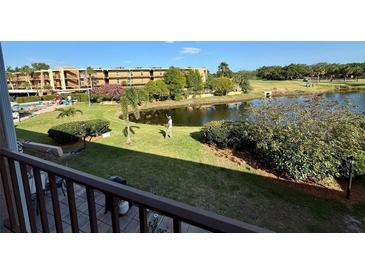 Overlooking the backyard with a peaceful pond view from the balcony at 225 Country Club Dr # A207, Largo, FL 33771