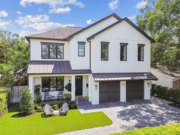 Stunning two-story home featuring a welcoming front porch and an attached two-car garage at 2402 W Parkland Blvd, Tampa, FL 33609