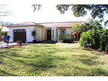Charming single-story home with a well-maintained lawn, inviting curb appeal, and an attached garage at 2460 Beacon Groves Blvd, Palm Harbor, FL 34683