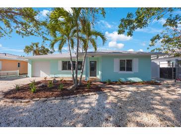 Charming light blue single-story home with tidy landscaping, new windows, and a one car garage at 280 41St Ave, St Pete Beach, FL 33706