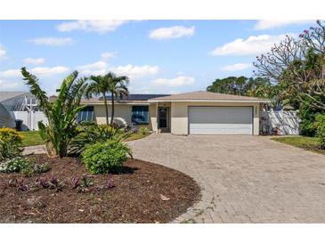 Charming single-story home with a well-manicured yard and brick driveway at 3497 Coquina Key Se Dr, St Petersburg, FL 33705