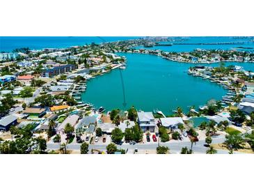 Expansive aerial view of waterfront homes and docks in a charming coastal community at 412 20Th Ave, Indian Rocks Beach, FL 33785