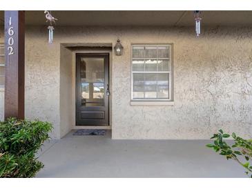 Charming front entryway featuring a secure door and a welcoming, covered porch area at 601 N Hercules Ave # 1602, Clearwater, FL 33765