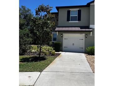 Charming two-story home featuring a one car garage, stone accents, and well-maintained landscaping at 6942 Ripple Pond Loop, Zephyrhills, FL 33541