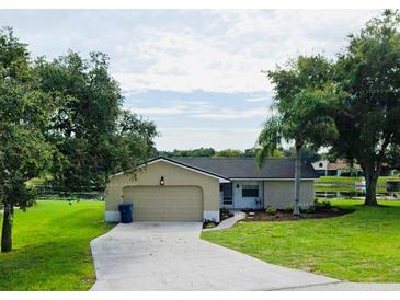 Charming single-story home with a well-maintained lawn and an attached garage at 8050 Roxburgh Ct, Weeki Wachee, FL 34613