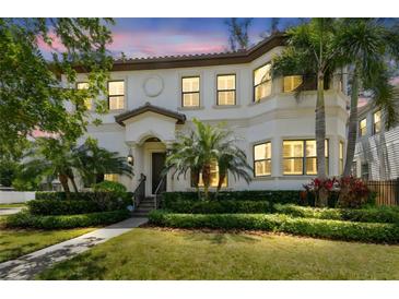Stately two-story home featuring lush landscaping, manicured lawn, and a tile roof at 134 Chesapeake Ave, Tampa, FL 33606
