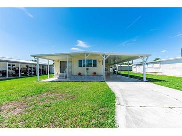 Charming single-story home featuring a covered carport and well-maintained front yard with sunny curb appeal at 36848 Beth Ave, Zephyrhills, FL 33542