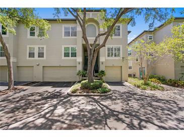 Charming townhouse with attached garages and mature landscaping in a desirable community with tree-lined streets at 728 Seagate Dr, Tampa, FL 33602