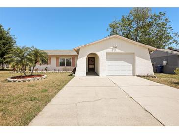 Charming single Gathering home with a well-maintained front yard and attached one-car garage at 2702 Ochatilla Rd, Holiday, FL 34691