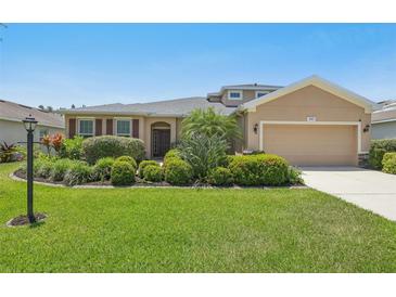 Well-maintained home featuring a lush lawn, mature landscaping, and inviting curb appeal at 2803 130Th E Ave, Parrish, FL 34219