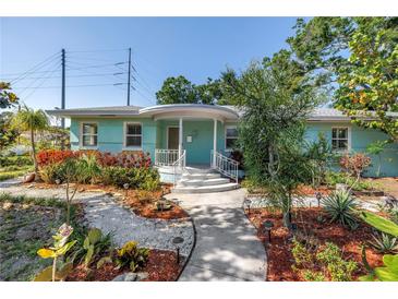 Charming single-story home featuring a well-manicured front yard with lush landscaping and a welcoming walkway at 5051 5Th S Ave, St Petersburg, FL 33707