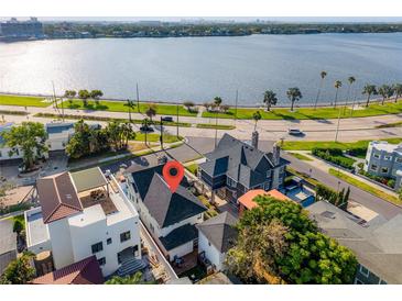 Stunning aerial view of waterfront home, with lush landscaping and a charming neighborhood at 723 S Brevard Ave, Tampa, FL 33606