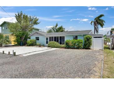 Charming single-story home with a gravel yard and colorful landscaping at 832 Seabreeze Dr, Ruskin, FL 33570