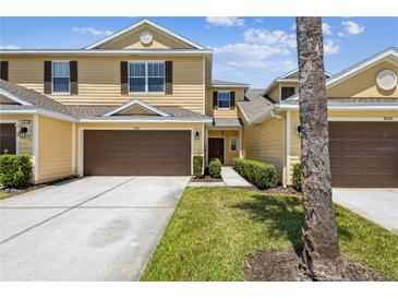 Charming two-story townhome featuring a well-maintained lawn, attached garage, and inviting curb appeal at 8518 Broken Willow Ct, Tampa, FL 33647