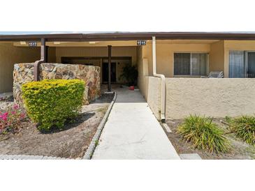 Inviting front entrance with a walkway and landscaped surroundings leading to the main door of the property at 1515 12Th Se Ct # 55, Largo, FL 33771