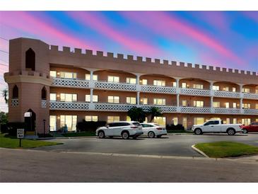 Unique three-story condo complex showcases castle-like design, white balconies, and ample parking at 2457 Ecuadorian Way # 63, Clearwater, FL 33763