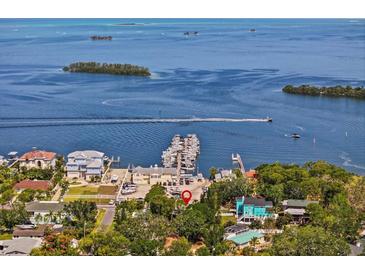 Stunning aerial view of waterfront property with a boat dock and breathtaking views of the bay and surrounding islands at 273 Shore Dr, Palm Harbor, FL 34683