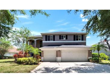 Two-story home featuring a three-car garage and well-maintained landscaping at 3314 Cypress Landing Dr, Valrico, FL 33596
