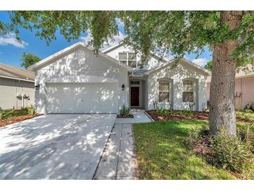 Charming single-story home with a well-manicured lawn and a two car garage at 12351 Ridgedale Dr, Hudson, FL 34669