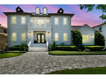 Stately two-story home features a brick driveway, manicured landscaping, and a welcoming front entrance at 2604 S Bryant Cir, Tampa, FL 33629