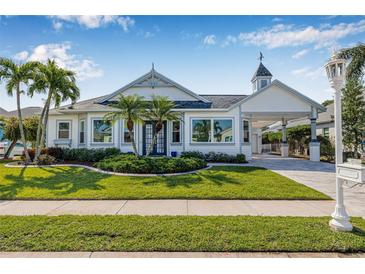 Charming single-story home with a well-manicured lawn and palm trees accenting the front yard at 4612 Barracuda Dr, Bradenton, FL 34208