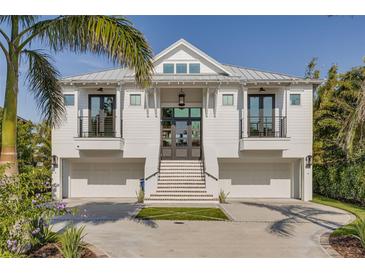 Stunning two-story home with a clean white facade, multi-car garage, and landscaped front yard at 721 Brightwaters Ne Blvd, St Petersburg, FL 33704